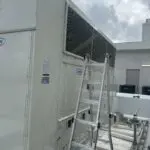 Beige rooftop unit with an access door removed