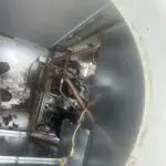Two compressors with copper pipes on a workbench