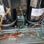 Black compressor with a fan inside a metal frame