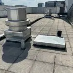 Round upblast exhaust fan with the cover hinged open